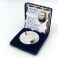 The silver medal is stored in a case with a certificate.